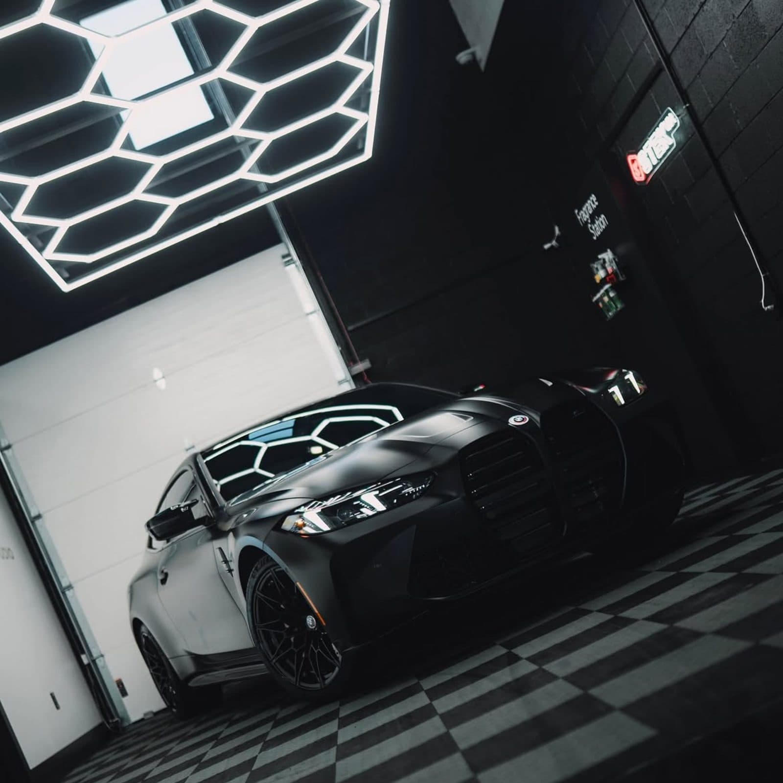Black BMW being prepared in a detailing studio