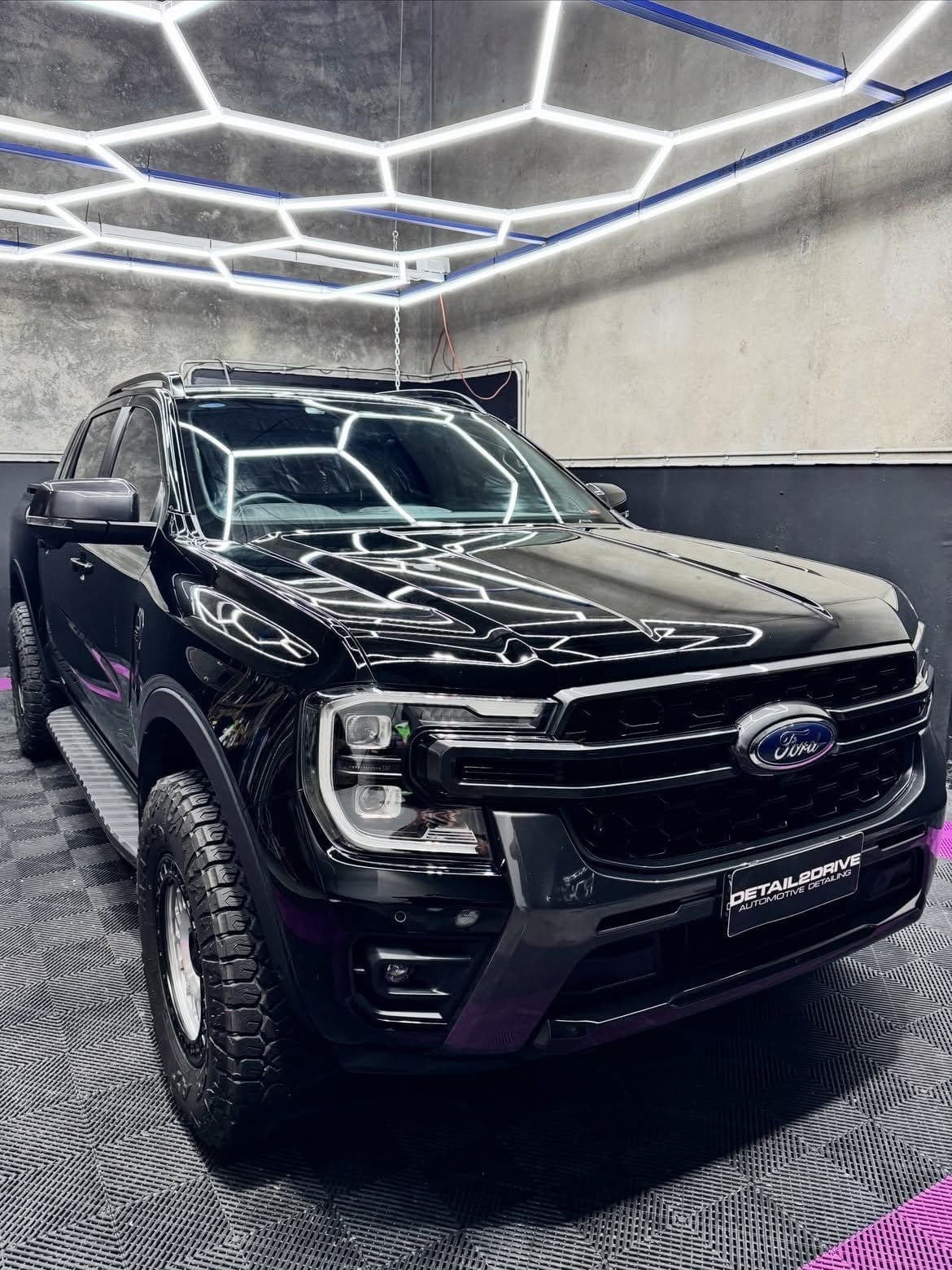Gloss black Ford Ranger reflecting the studio light rig after a full detail